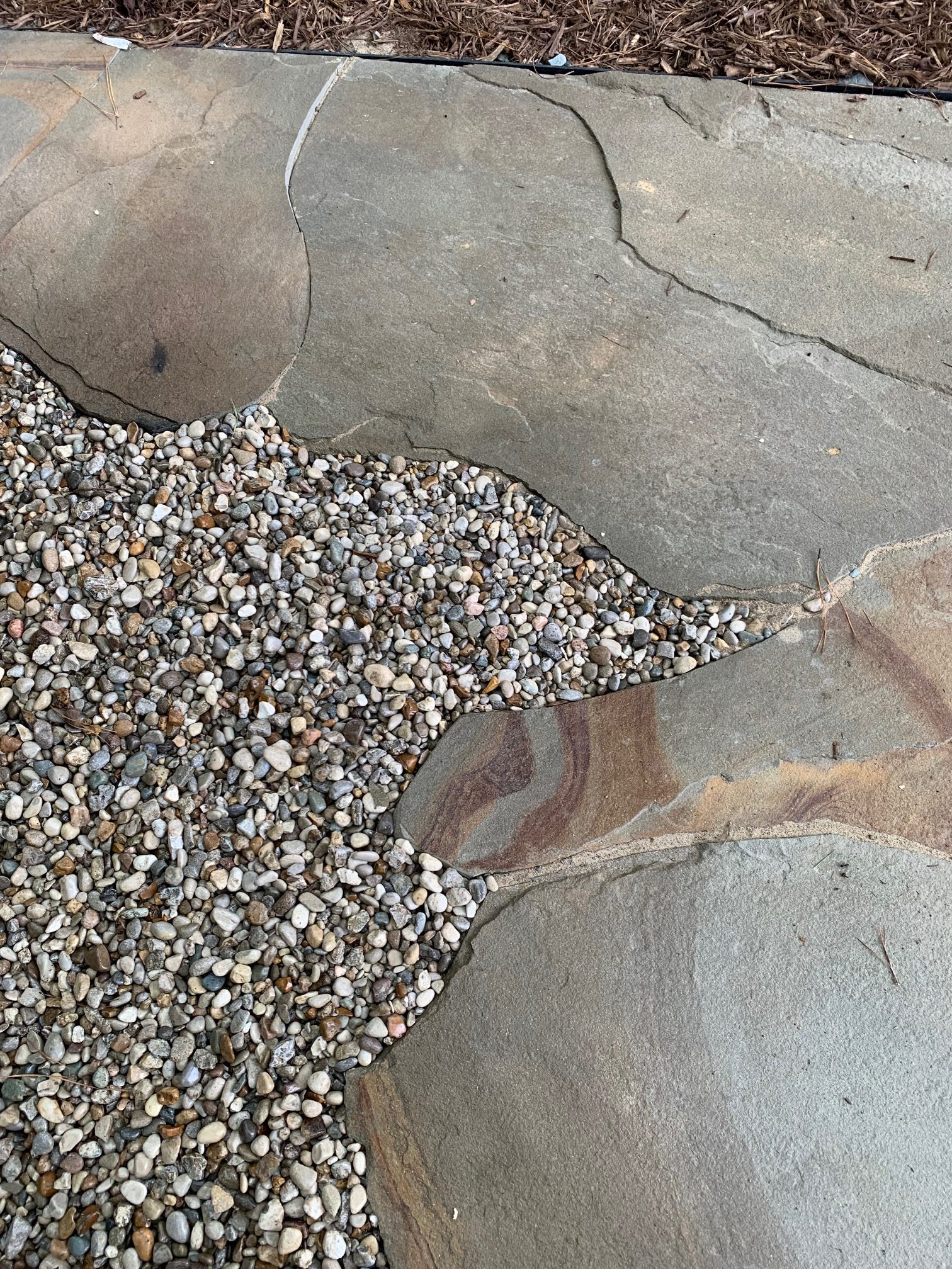 Pebble Gravel Landscaping Services in Waxhaw NC | Honeycutt Landscaping, Inc Smooth pebble gravel landscaping feature expertly installed by Honeycutt Landscaping, Inc. in Waxhaw, NC, enhancing walkways, garden beds, and outdoor spaces with natural texture and durability. Call (704) 389-0159 today to schedule professional gravel installation and landscaping services with Honeycutt Landscaping, Inc., your trusted local experts.